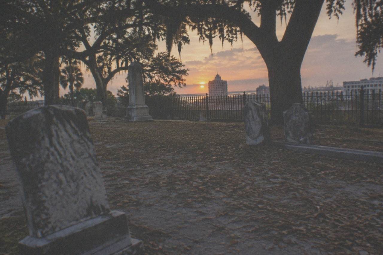 Historic Broadway cemetery headstones under evening light in Galveston