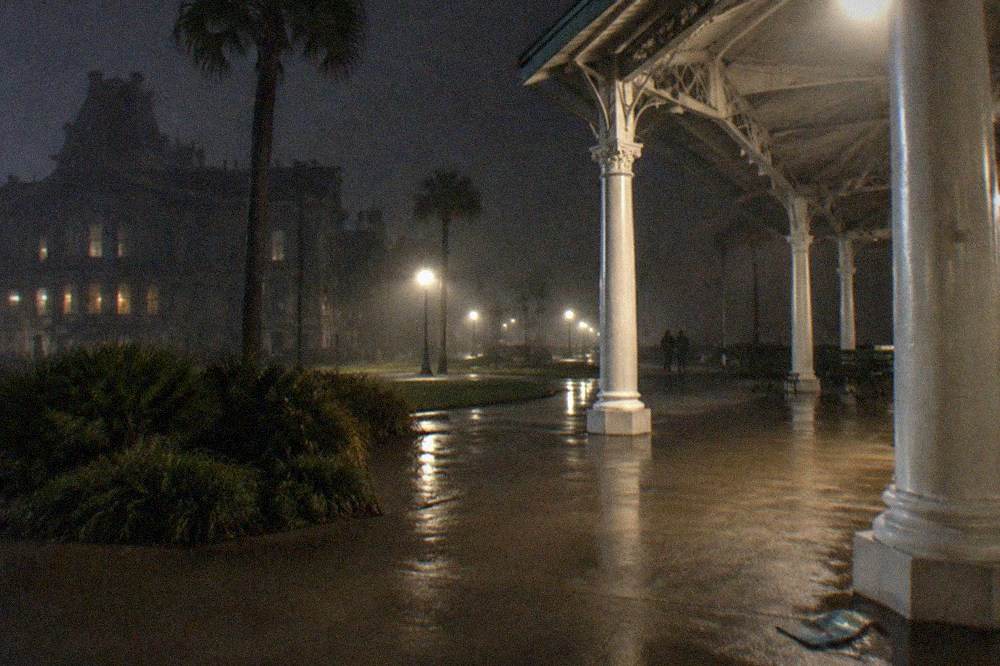 Nighttime meeting point on a downtown Galveston corner with a lit gazebo and historic library building